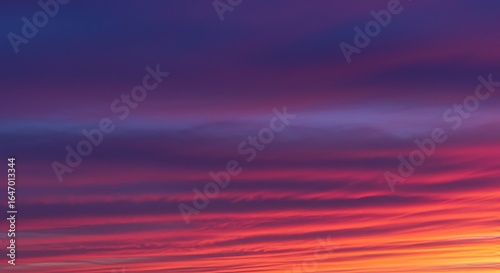 A vibrant sunset with streaky purple and pink clouds.

