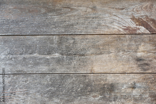 Tableau sur toile Three horizontal wooden boards worn by time brown and gray