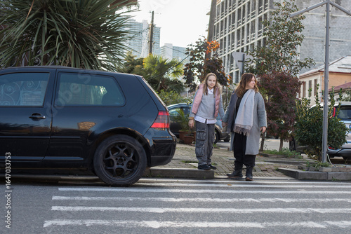 Wallpaper Mural Happy woman and young child girl standing on crosswalk Torontodigital.ca