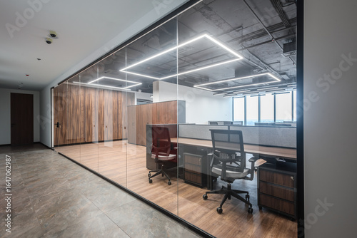 Business interior with office coworking zone and glass doors. Modern coworking space behind transparent glass wall, minimal interior