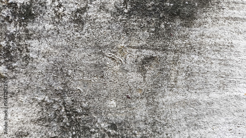 Фотография Damaged wall surface with rough cracks and dirt