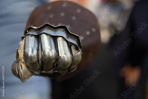 Φωτογραφία Medieval knight clenching fist in metal gauntlet