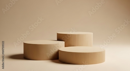 Photo of three beige cylinder podiums for product display and presentation stage