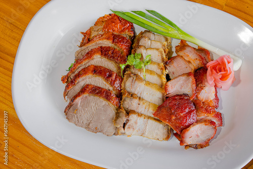 Slika na platnu Top view of a traditional Chinese roast pork assortment including crispy belly, char siu, and roast pork loin, garnished for serving