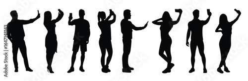 silhouette of people taking selfies with their smartphones