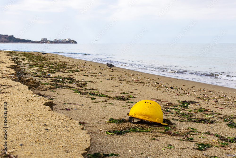 yellow lifeguard helmet on the sandy beach on a cloudy day near Marmara sea yellow lifeguard helmet on the sandy beach on a cloudy day near Marmara sea