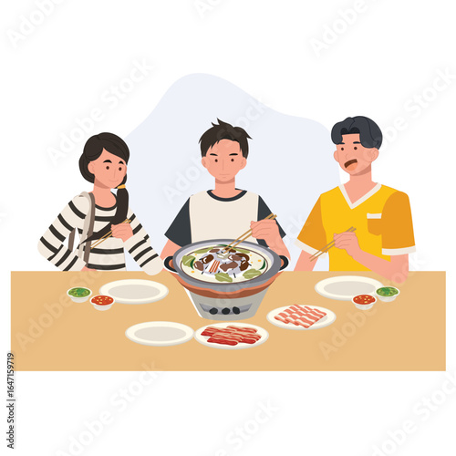 thai barbecue moo krata with friends enjoying grilled pork and vegetables on a tabletop grill at dinner