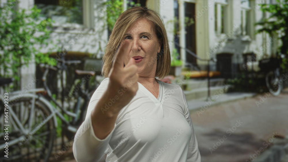 Fototapeta premium Caucasian woman counting fingers while celebrating and smiling beside bicycles on sunlit street; joy success celebration achievement.