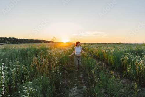 Wallpaper Mural Teenage girl in serene sunset field Torontodigital.ca