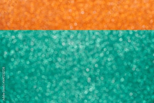 Colorful orange and green glitter large bokeh background