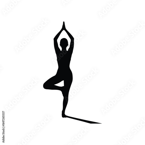 Silhouette of a person in a yoga tree pose casting a shadow