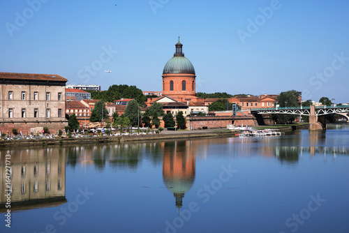 Cityscape of Toulouse city and its reflections in Garonne river