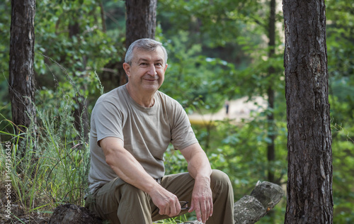 Pensive European senior man, emotional portrait of reflection and life challenges. Emotive portrait of a 55–65 year old man outdoors
