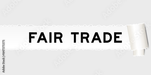 Ripped gray paper background that have word fair trade under torn part