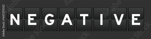 Black color analog flip board with word negative on gray background