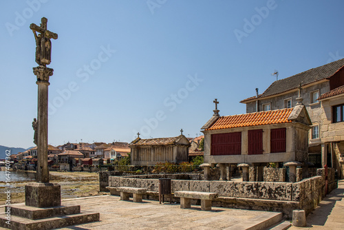 Фотография Traditional stone and wood granaries on the banks of the Combarro estuary