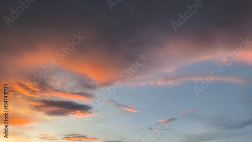 sky in the orange and blue colors effect of light pastel colored of sunset clouds cloud on the sunset sky background with a pastel color