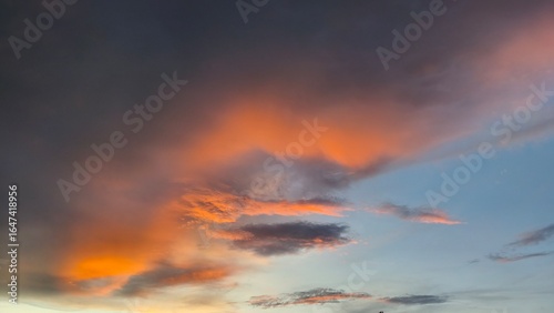 sky in the orange and blue colors effect of light pastel colored of sunset clouds cloud on the sunset sky background with a pastel color
