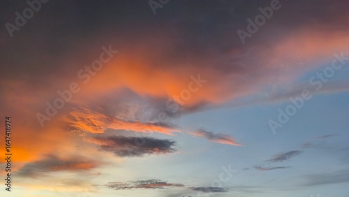 sky in the orange and blue colors effect of light pastel colored of sunset clouds cloud on the sunset sky background with a pastel color
