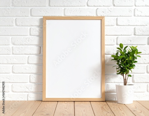 Vertical blank wooden frame mockup on white brick wall with green plant