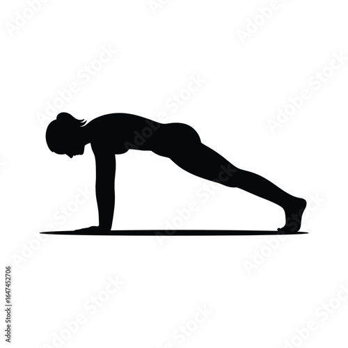 Silhouette of a woman performing a plank exercise on a yoga mat