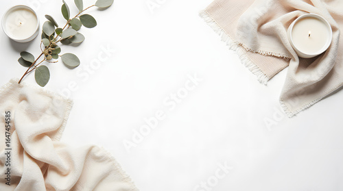 Soft beige textiles and eucalyptus branches on white background