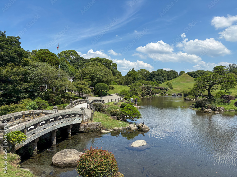 Fototapeta premium Stone Bridge and Pond at Suizenji Jojuen Garden