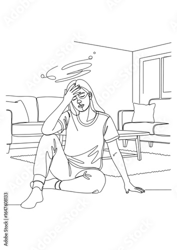 A woman is dizzy and holds her head while sitting on the floor.