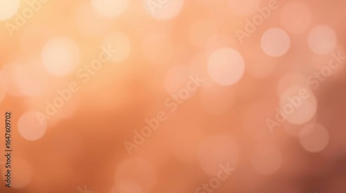 Blurred abstract background with bokeh lights in warm shades of orange peach and brown