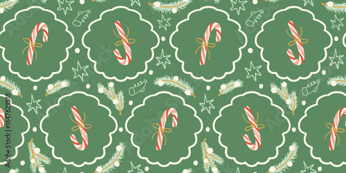 Christmas candy canes seamless pattern. Candy canes with red stripes, bows, stars and tree branches holiday season background. Wrapping paper, fabric design.