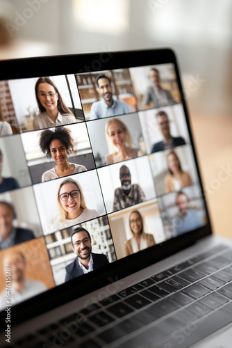 A close-up of a laptop screen showing a diverse group video call, emphasizing collaborative online learning and interaction.