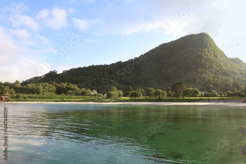 Stunning white sand beach in Hareid island, Norway. White beach below majestic mountains in Sunnmore.