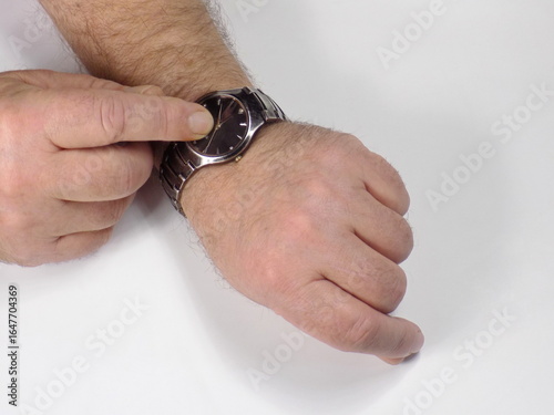 The watch on the man's hand shows the elapsed time.
