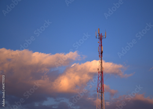 Cell phone antenna tower on a background of clouds