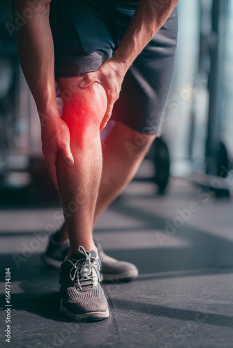 Swollen knee from a sports injury highlighted in a gym setting, focusing on athlete care.
