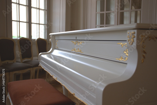White grand piano near the window