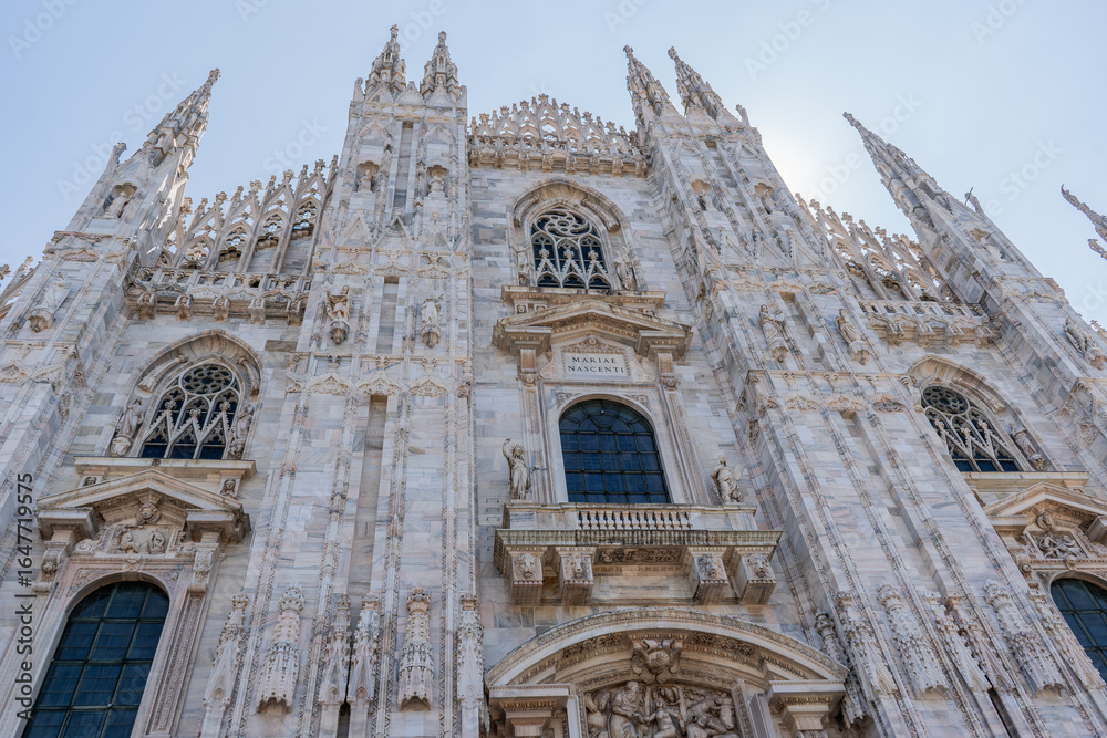 Fototapeta premium Duomo di Milano square in Milan city. Gothic Italian architecture. Italy. Sculptures and statues facade decor details