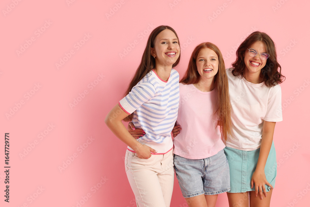 Obraz premium Portrait of happy friends on pink background, space for text
