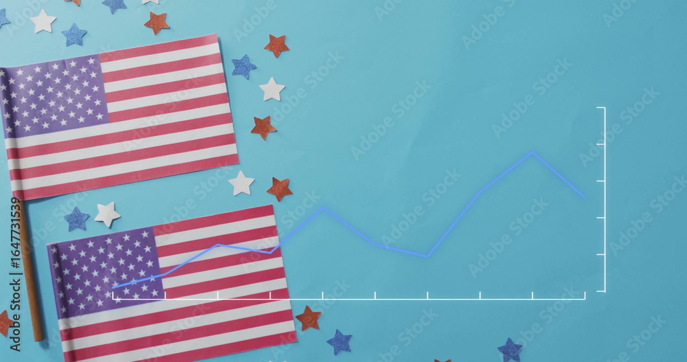 Fototapeta premium Displaying two American flags on sticks lying on tabletop, with confetti, line chart, copy space