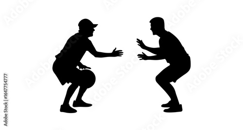Silhouette of two men in a dynamic, crouching position, likely during a basketball practice drill or game.
