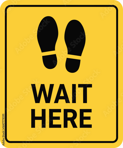 A yellow wait here sign with footprint symbols isolated on white background, indicating the designated waiting area for social distancing