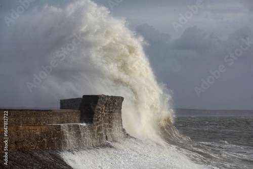 Giant waves hitting the sea wall and lighthouse at Porthcawl.