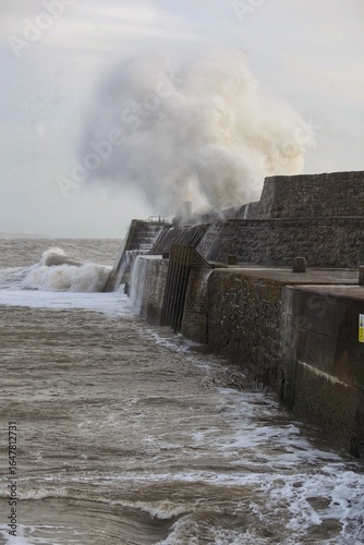 Giant waves hitting the sea wall and lighthouse at Porthcawl.