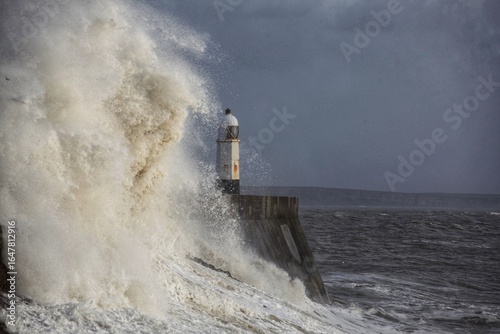 Giant waves hitting the sea wall and lighthouse at Porthcawl.