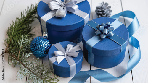 Blue gift boxes with silver and blue ribbons and pine sprigs silver ribbon pine cone