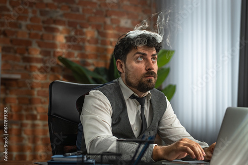 Quadro em tela Businessman works in a loft style office and experiences stress from overwork