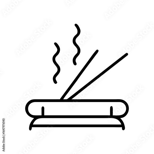 Incense sticks burning on holder with smoke wafting gently  