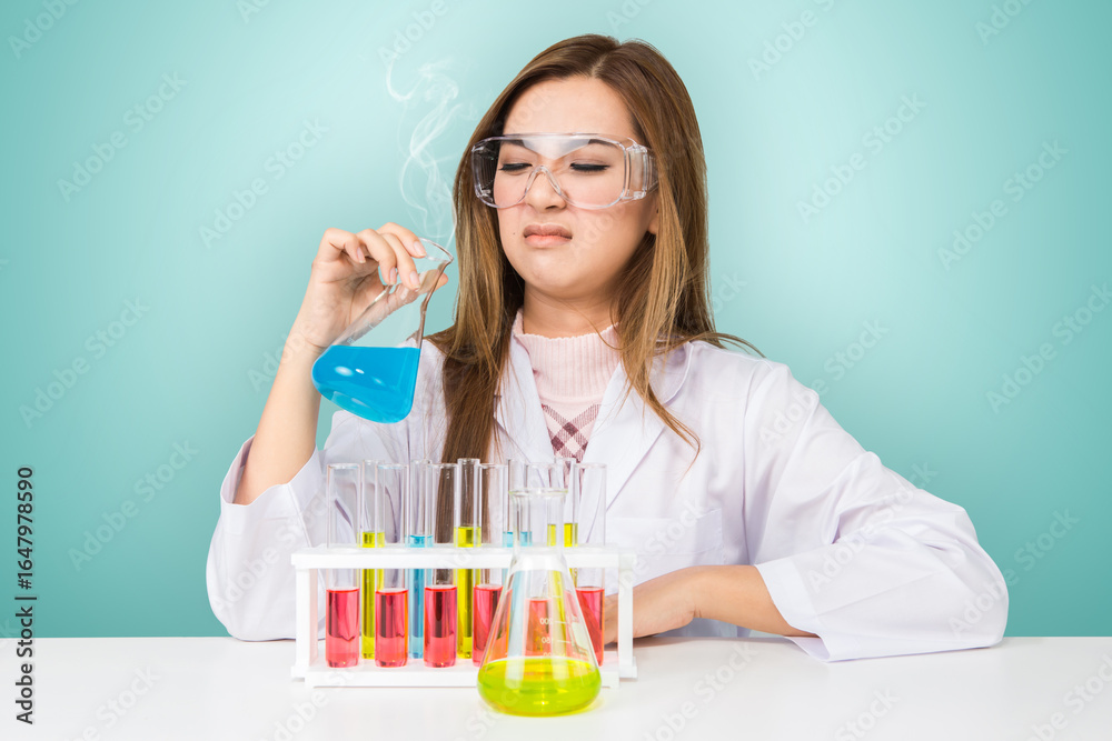 Asian scientific researcher holding at a liquid solution in a lab Asian scientific researcher holding at a liquid solution in a lab