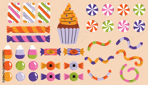 Colorful Halloween candy set featuring lollipops, marshmallows, gummy worms, candy corn and muffin.