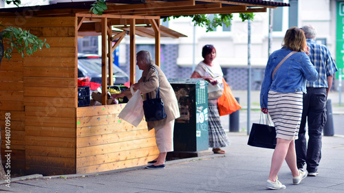 Szczecin, Poland. 16 July 2025. Crowds of people shopping at street vendors along the sidewalks
